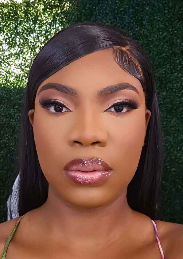 Bella Bone Straight 180 Density Human Hair Wig styled on a woman with flawless makeup.