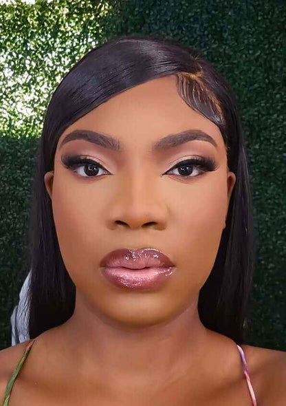 Bella Bone Straight 180 Density Human Hair Wig styled on a woman with flawless makeup.